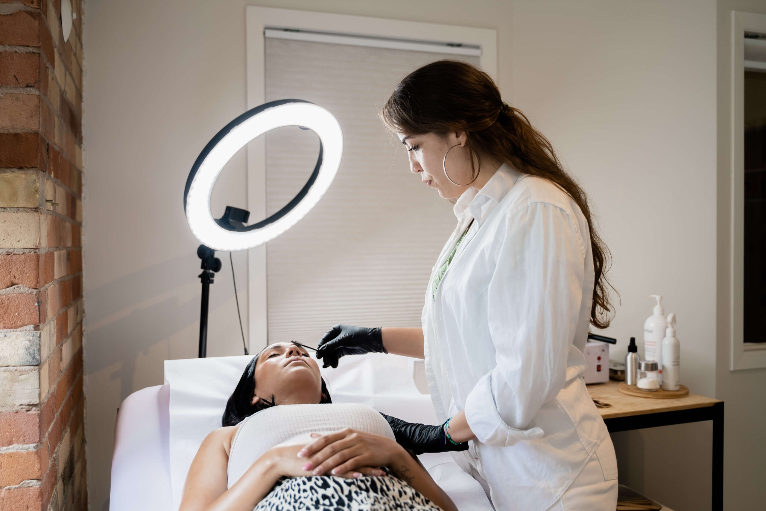 A woman is getting a facial treatment in a beauty salon.