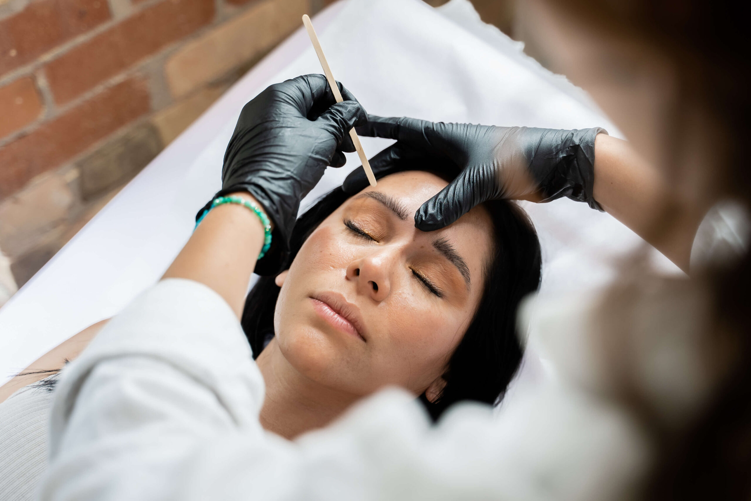 A woman getting her eyebrows tattooed.